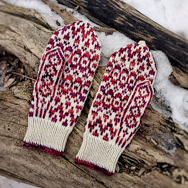 The palm side of a pair of mittens, showcasing its geometric motif.