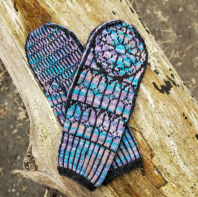 A pair of mittens knit to look like cathedral stained glass windows.