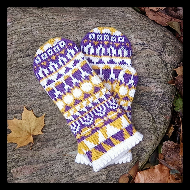 A pair of purple, yellow, and white mittens with all over geometric shapes.